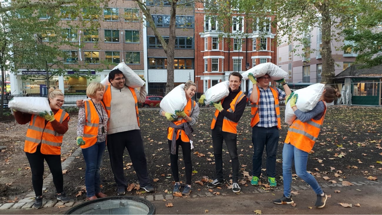 Workers carrying sand bags